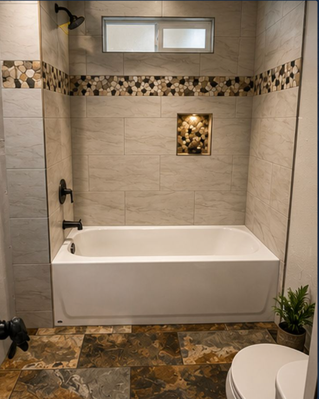 Custom bathtub tile surround with decorative accent installed by JAC Tiling LLC